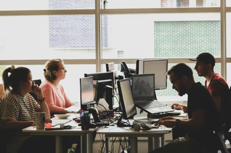 A group of techies working at the office desk