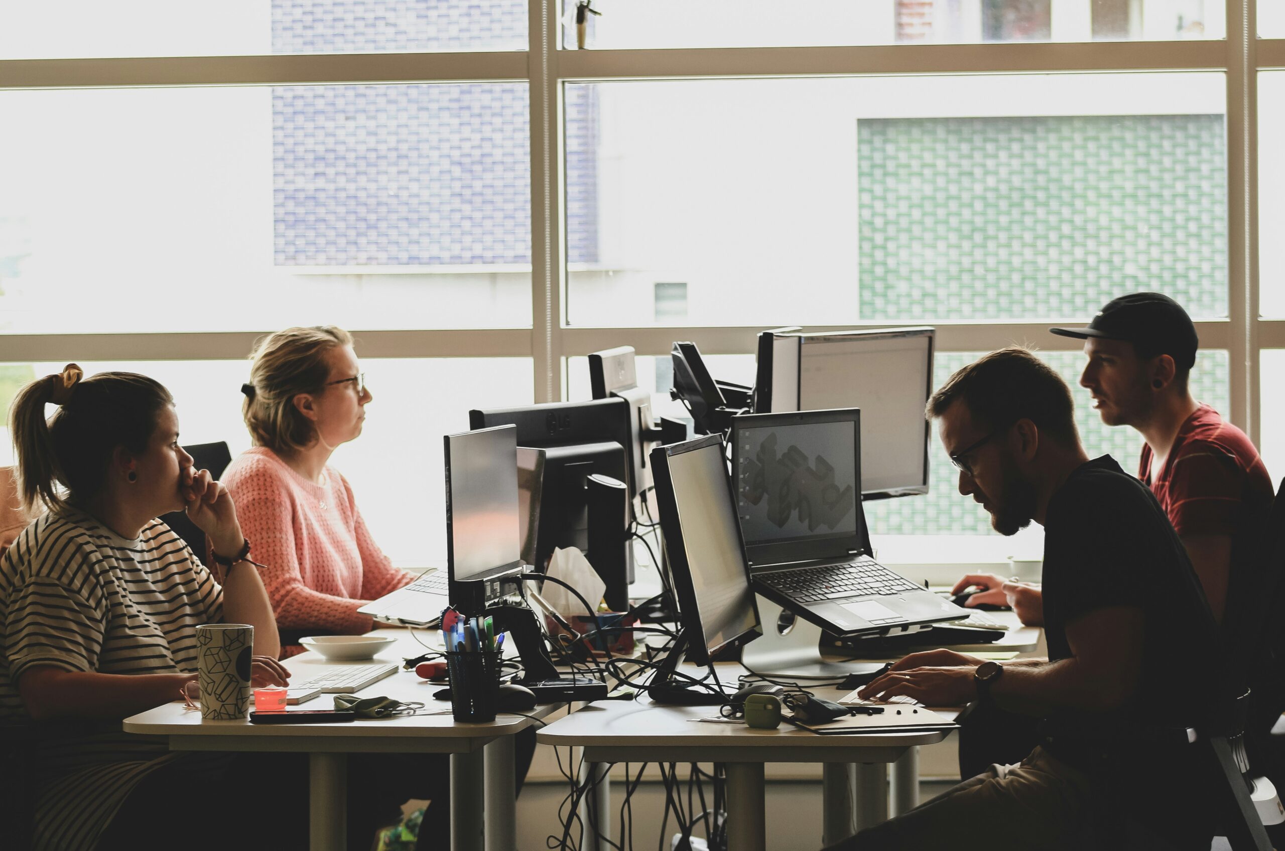A group of techies working at the office desk